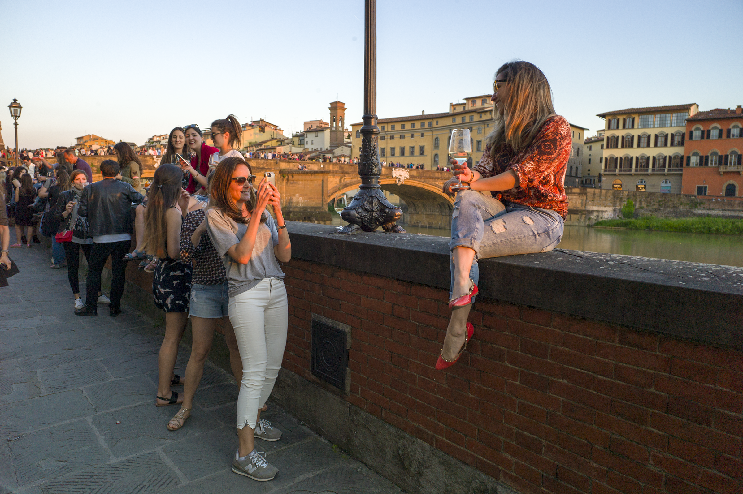 Woman photographing at sunse, Florence, Italy